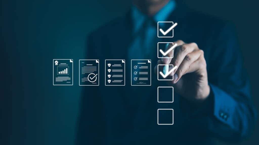 Businessman ticking compliance checklist for commercial property documents